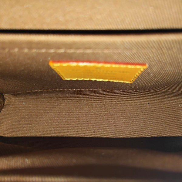 TRUNK Monogram Coated Canvas Brown