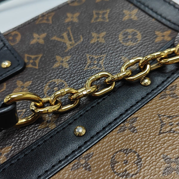 TRUNK Monogram Coated Canvas Brown