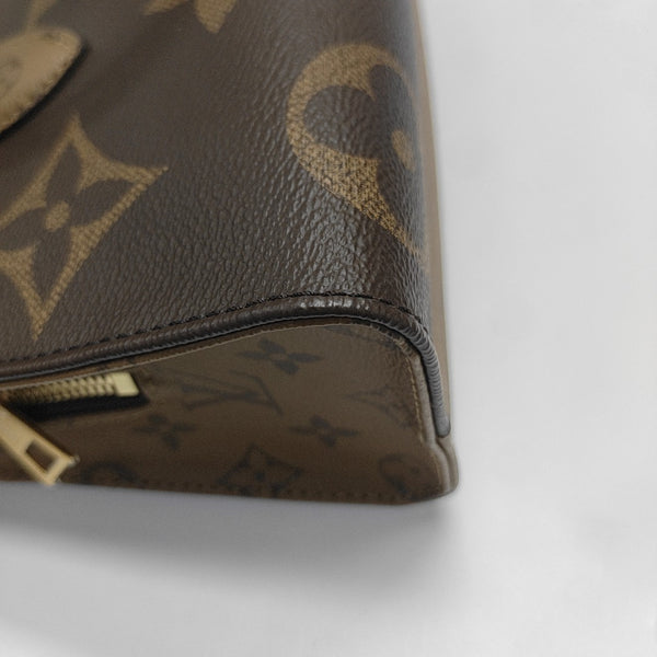 ONTHEGO EAST WEST PM Monogram Coated Canvas Brown