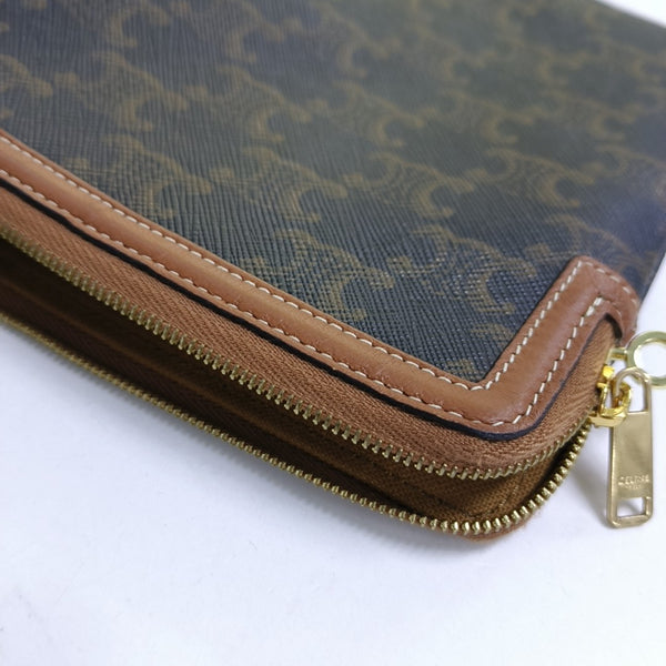 Authenticated pre-owned TRIOMPHE Small Coated Canvas Brown - Clutch at Looply