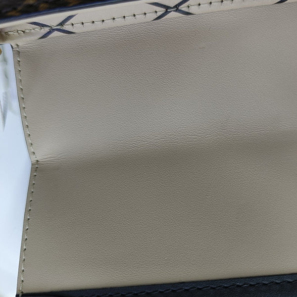 TRUNK Monogram Coated Canvas Brown