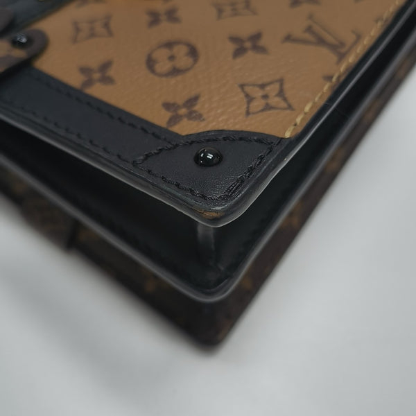 TRUNK Monogram Coated Canvas Brown