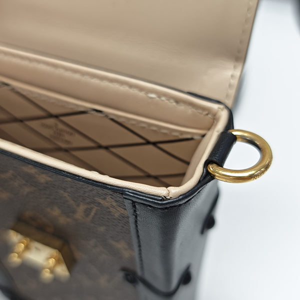 TRUNK Monogram Coated Canvas Brown