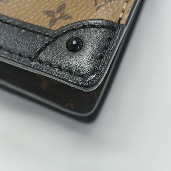 TRUNK Monogram Coated Canvas Brown