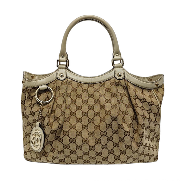 Authenticated pre-owned  Sukey Monogram Canvas Beige - Top Handle Bag at Looply