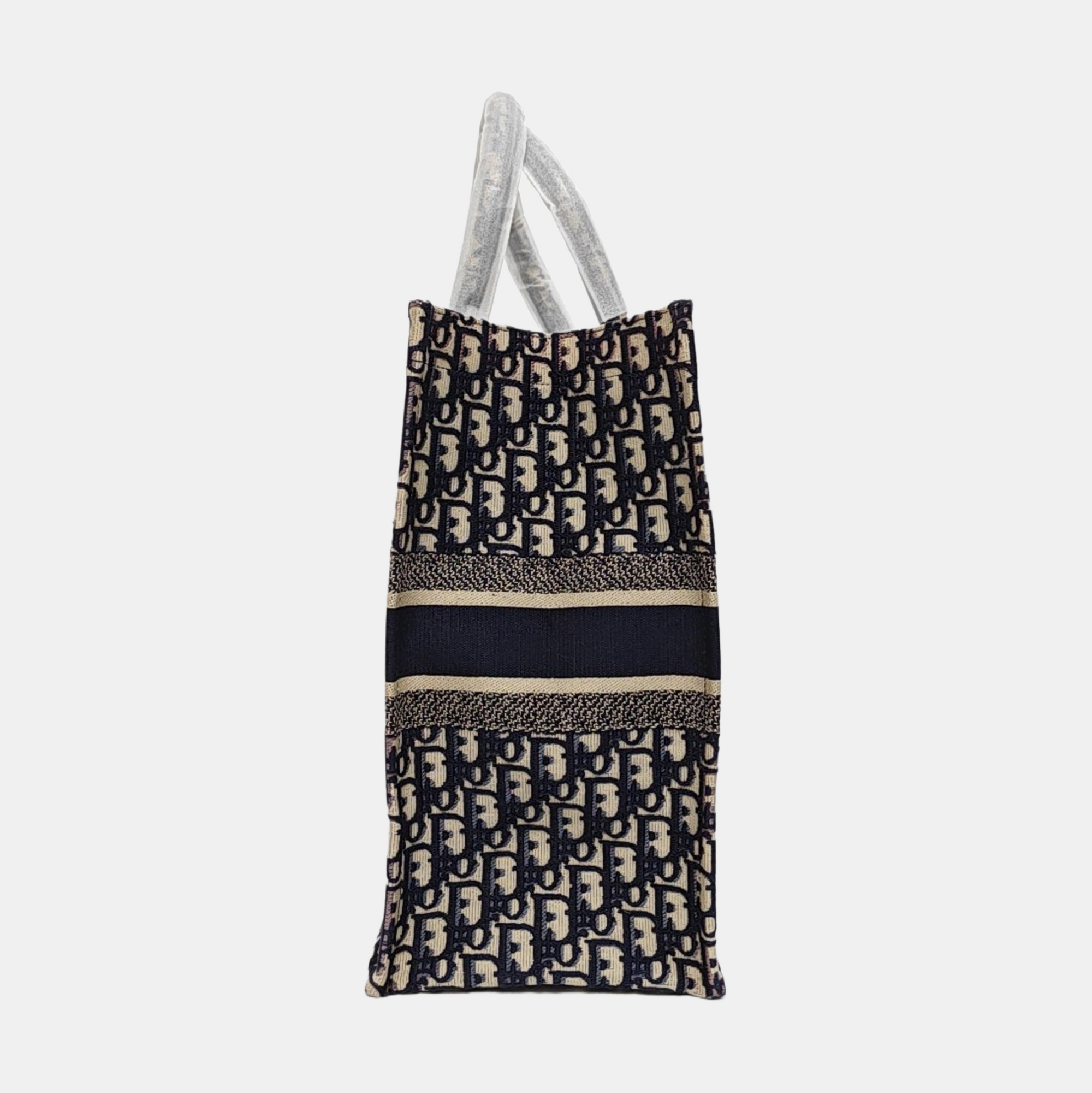 Authenticated pre-owned  Book Tote Large Monogram Canvas Beige - Tote Bag at Looply