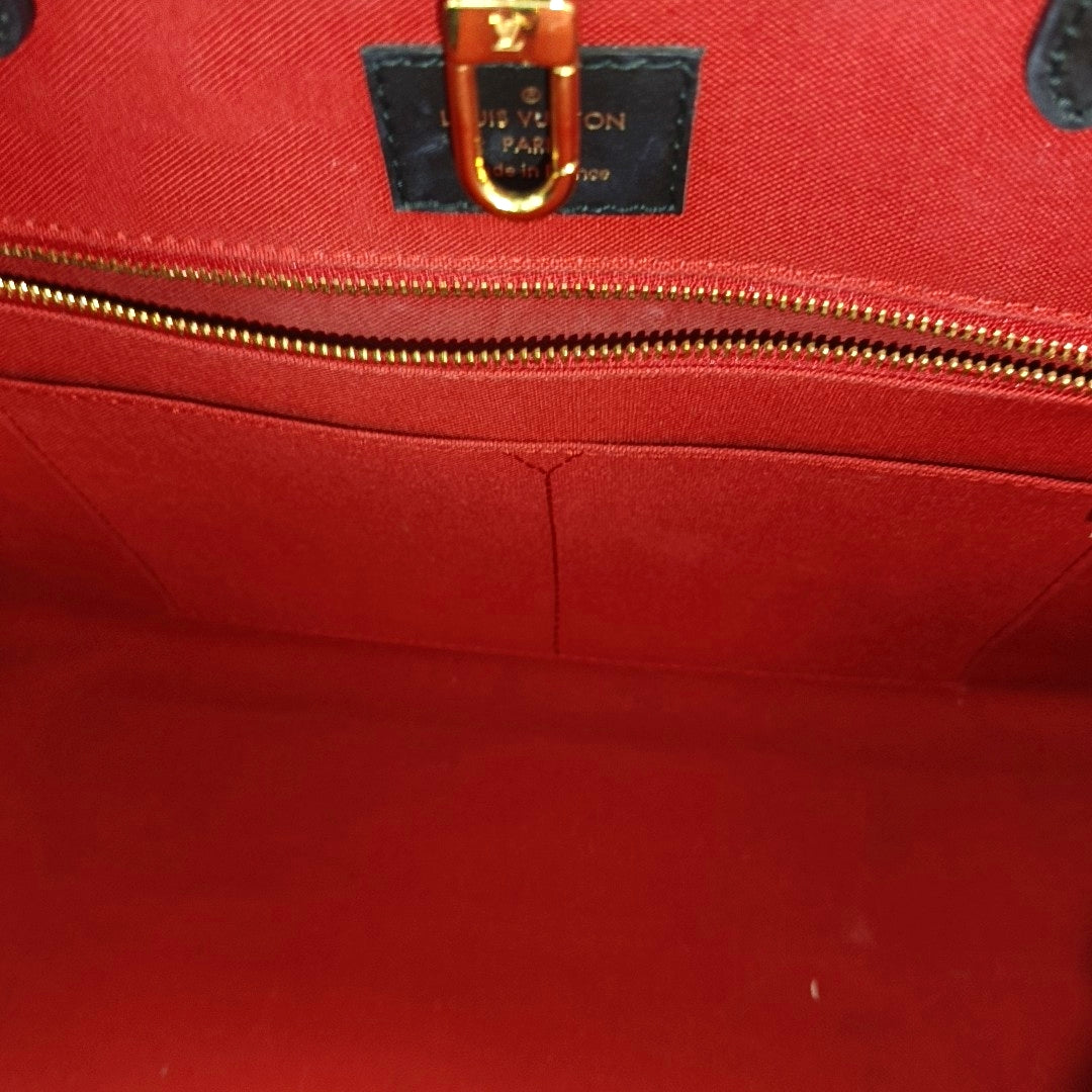 ONTHEGO MM Monogram Coated Canvas Brown