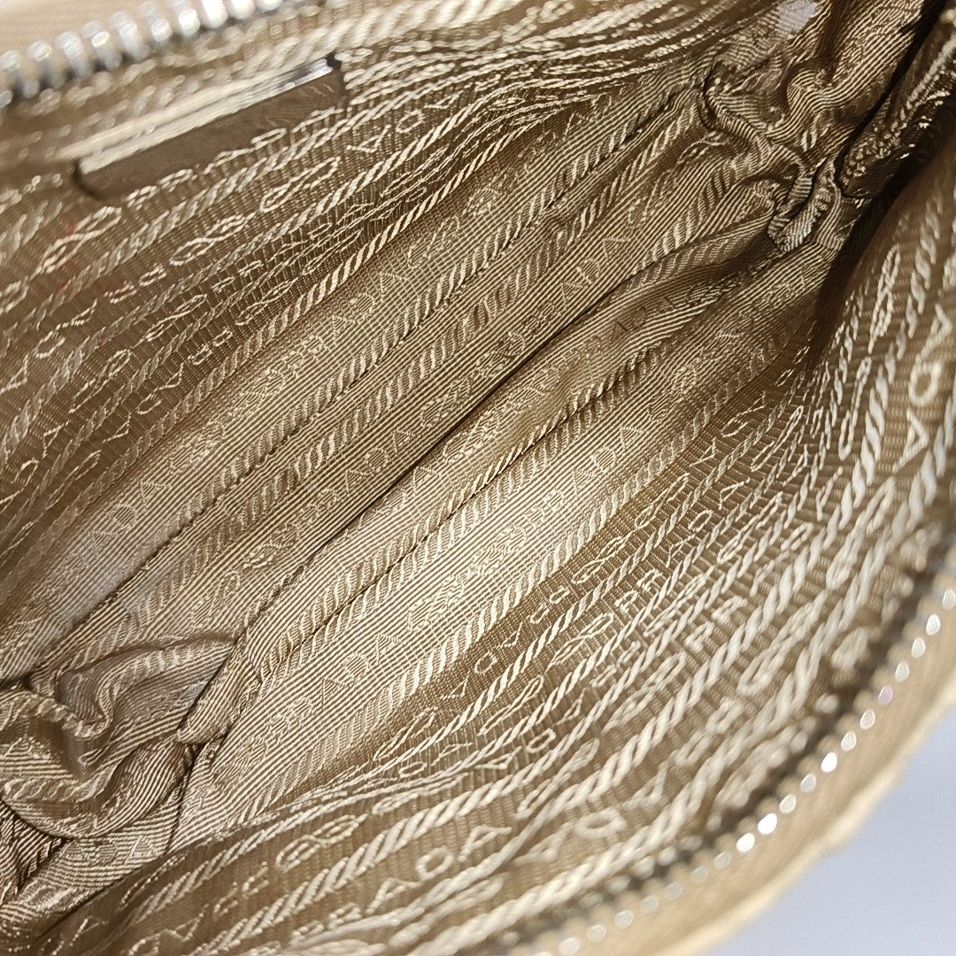 Authenticated pre-owned  Re-Edition2005 Mini Quilted Nylon Beige - Top Handle Bag at Looply