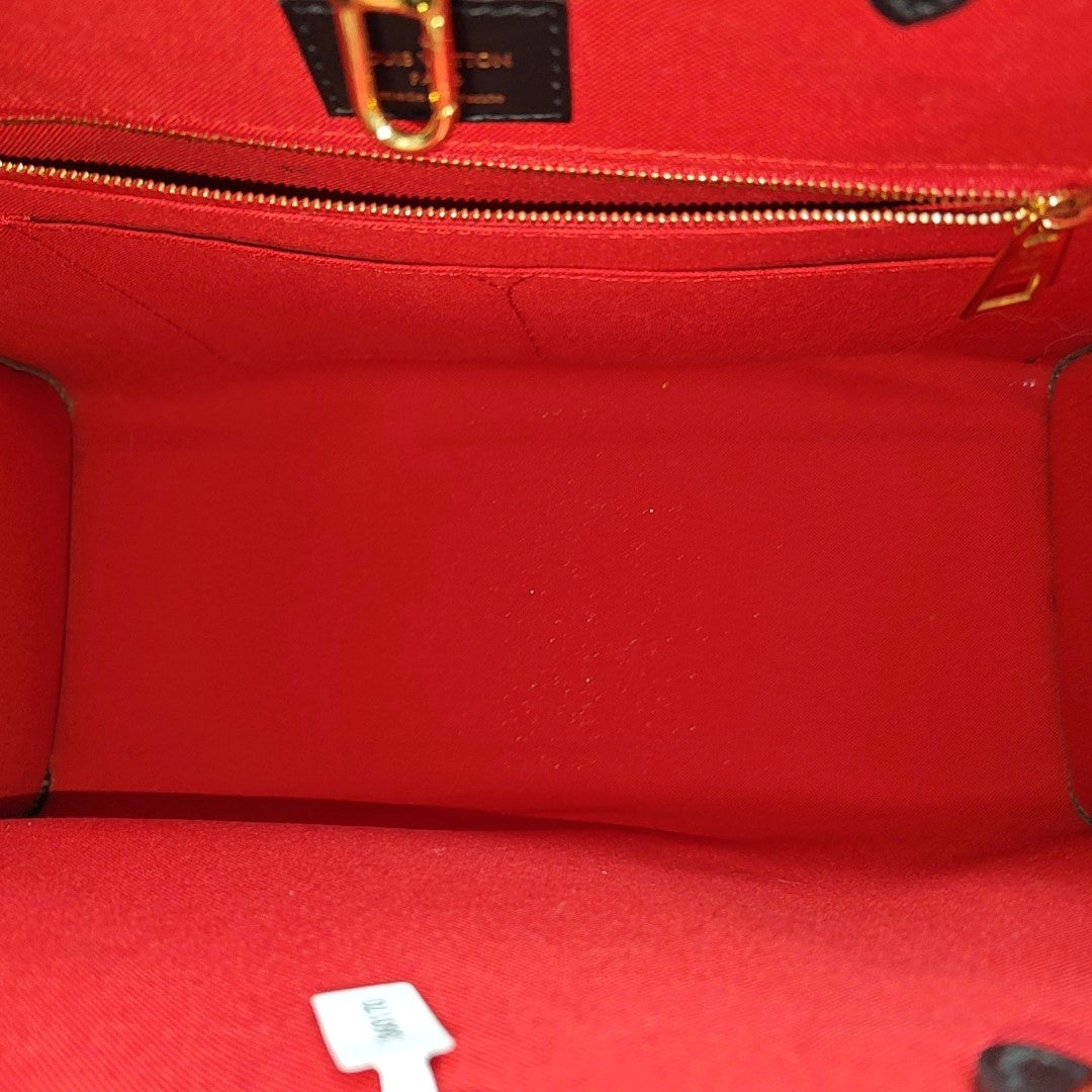 ONTHEGO MM Monogram Coated Canvas Brown