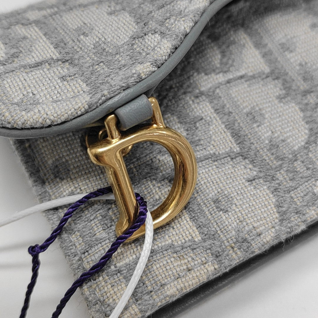 Authenticated pre-owned  Saddle Oblique Fabric Gray Card Holder - Card Holder at Looply
