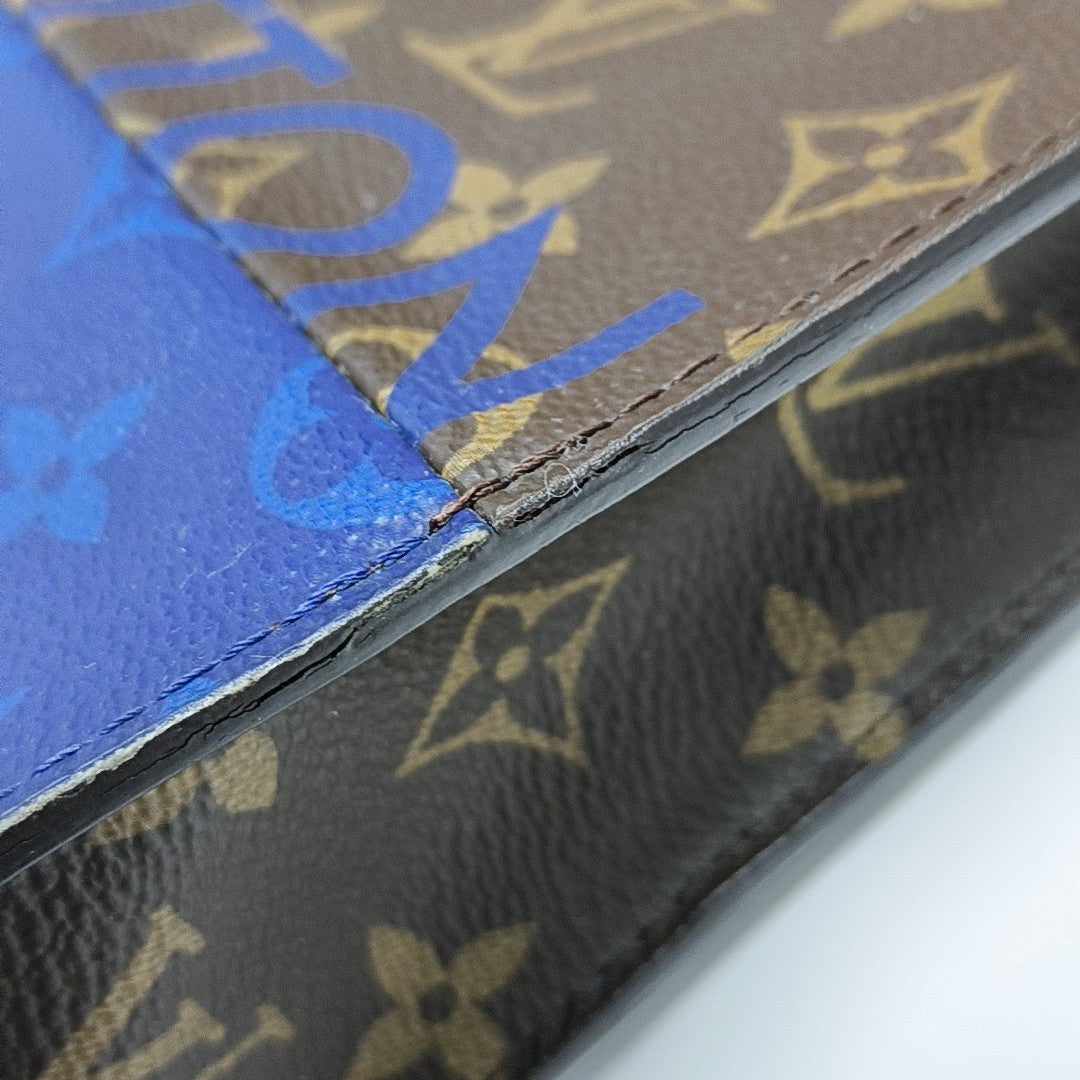 Pochette Voyag MM Monogram Coated Canvas Blue