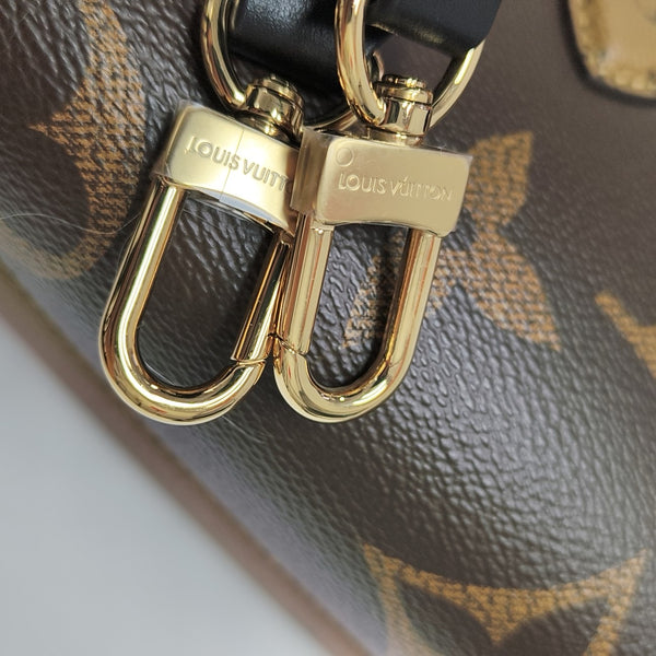 ONTHEGO EAST WEST Chain Monogram Coated Canvas Brown