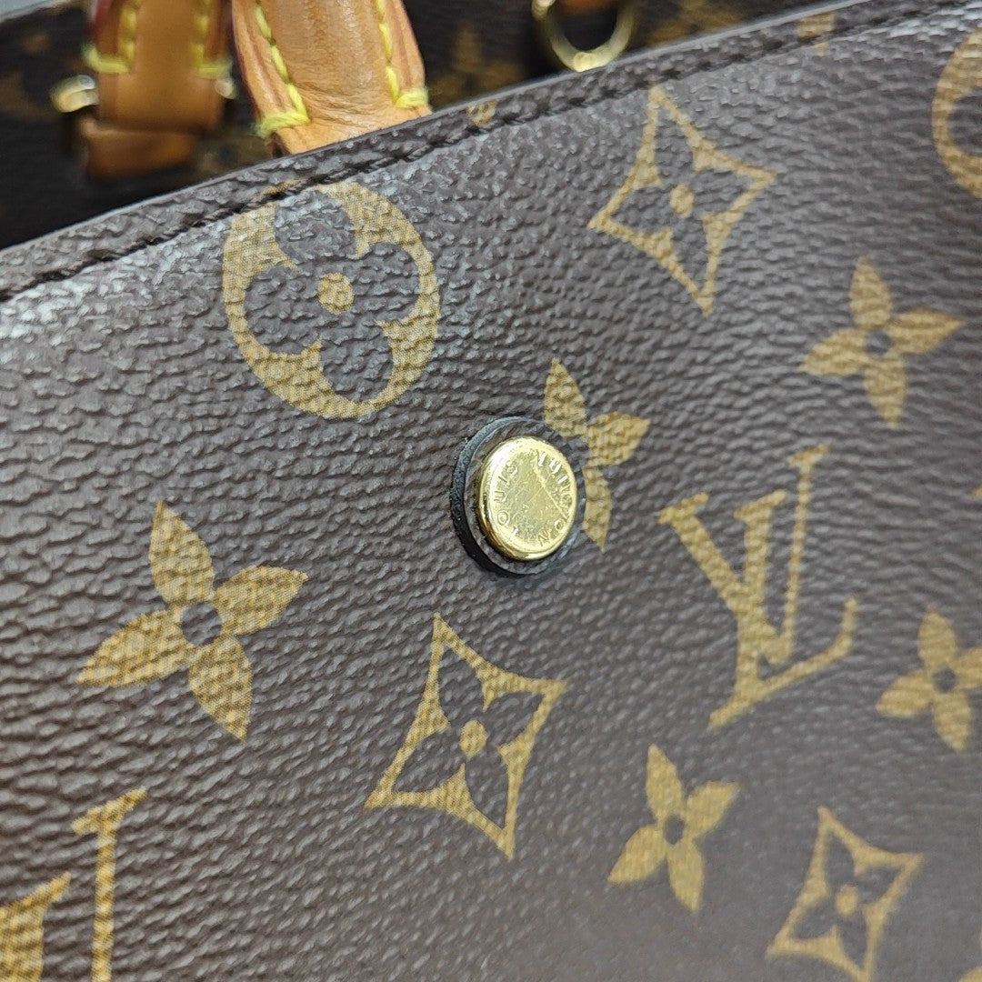 MONTAIGNE GM Monogram Coated Canvas Brown