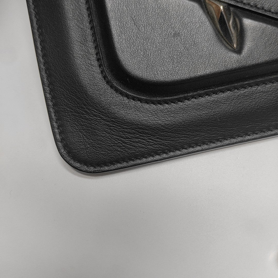 Authenticated pre-owned  Monster Calfskin Black - Clutch at Looply