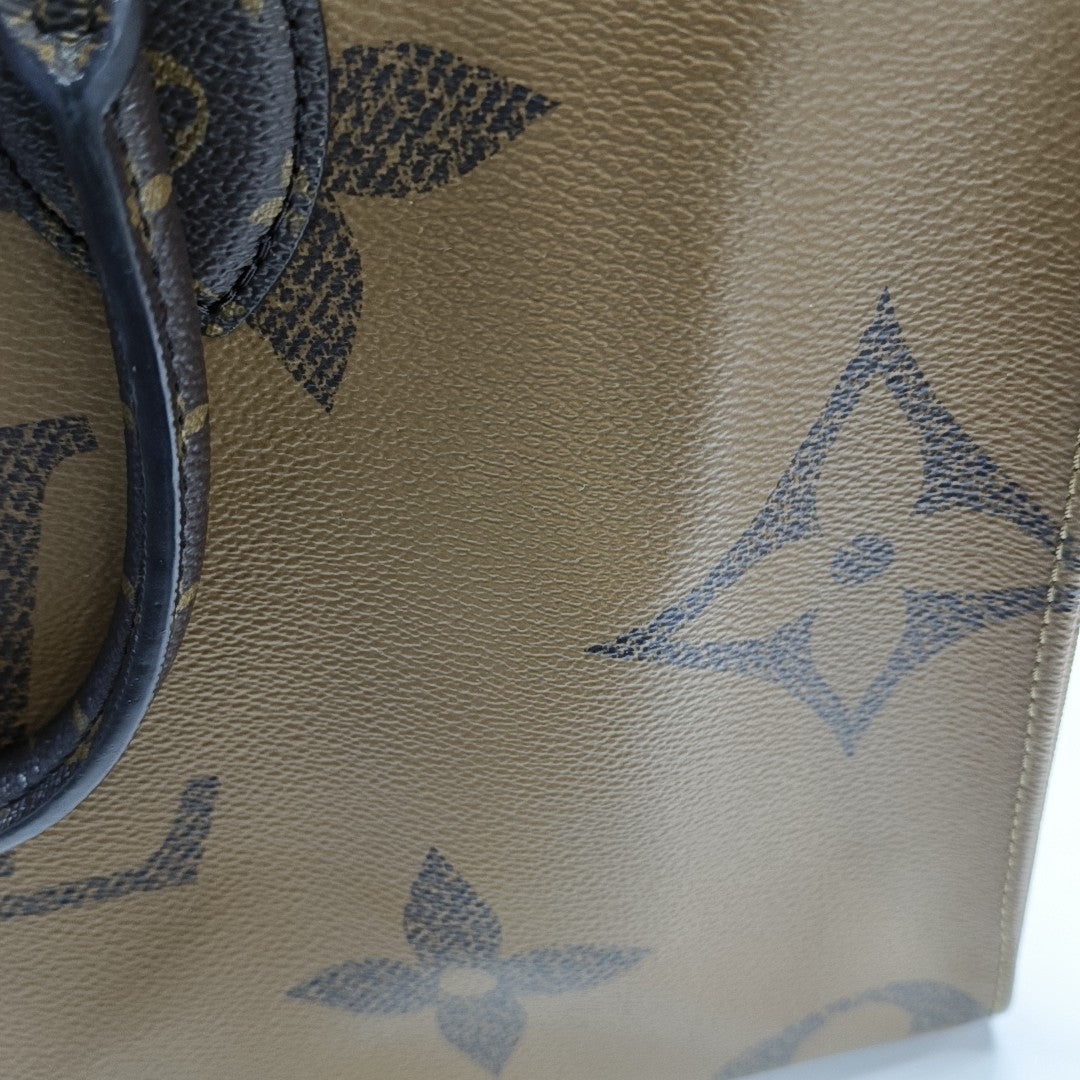 ONTHEGO MM Monogram Coated Canvas Brown