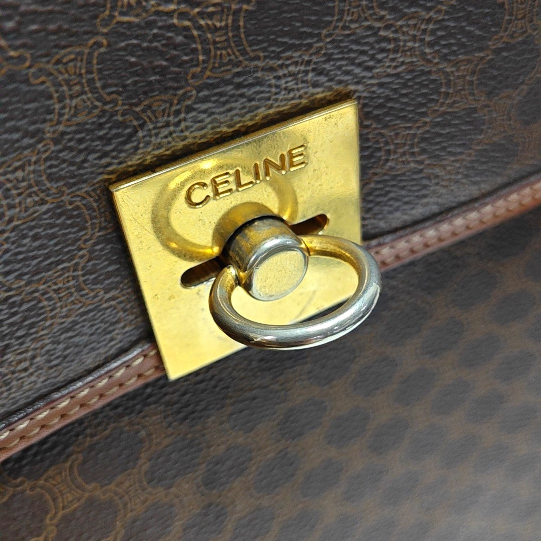 Authenticated pre-owned  MACADAM BLASON TRIOMPHE Coated Canvas Brown - Top Handle Bag at Looply