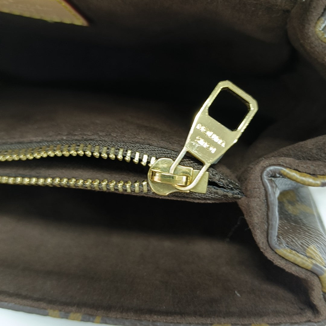 MÉTIS EAST WEST Monogram Coated Canvas Brown