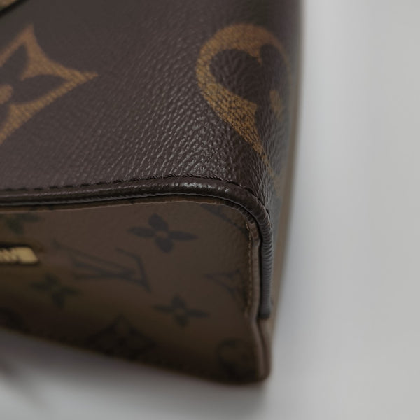 ONTHEGO EAST WEST Chain Monogram Coated Canvas Brown