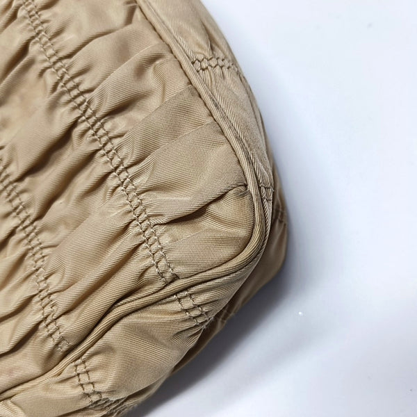 Authenticated pre-owned  Re-Edition2005 Mini Quilted Nylon Beige - Top Handle Bag at Looply