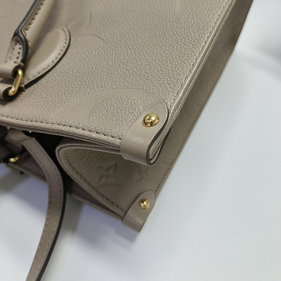 Authenticated pre-owned  ONTHEGO MM Monogram Calfskin Grey - Tote Bag at Looply