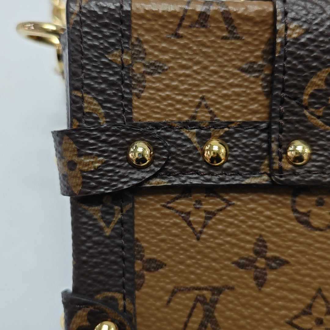 TRUNK Monogram Coated Canvas Brown