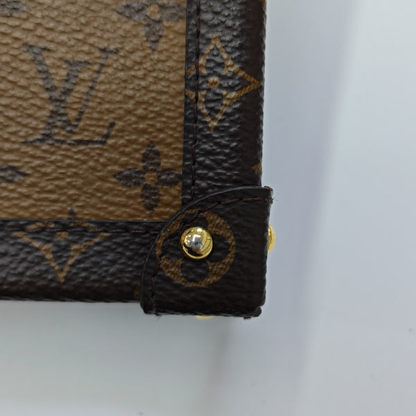TRUNK Monogram Coated Canvas Brown