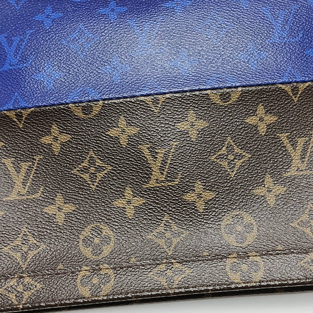 Pochette Voyag MM Monogram Coated Canvas Blue