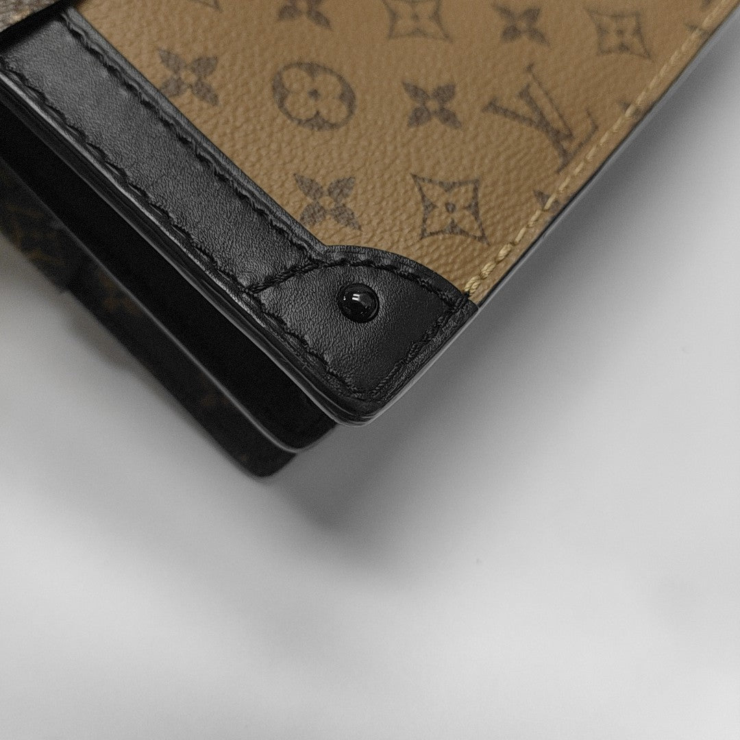 TRUNK Monogram Coated Canvas Brown