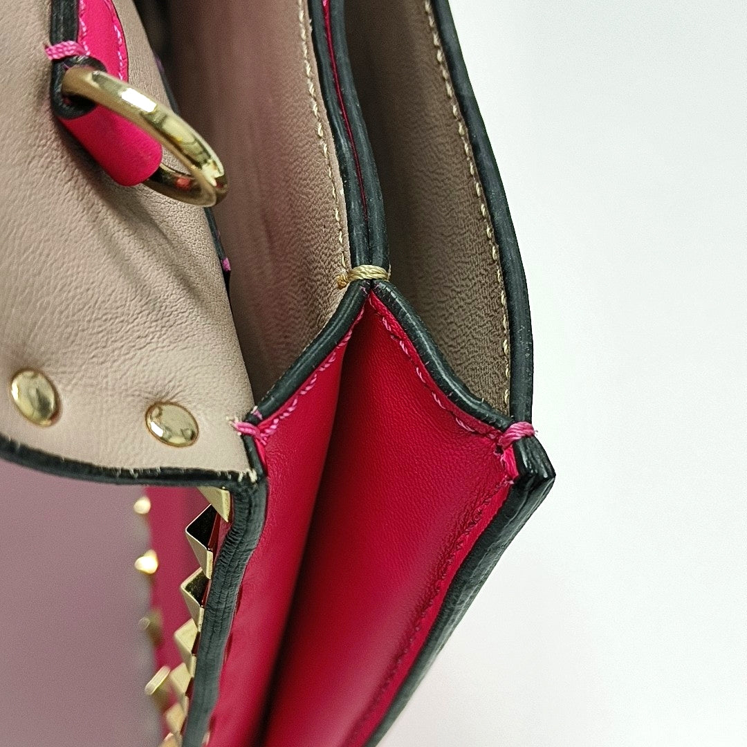 Authenticated pre-owned  Rockstud Lambskin Pink - Clutch at Looply