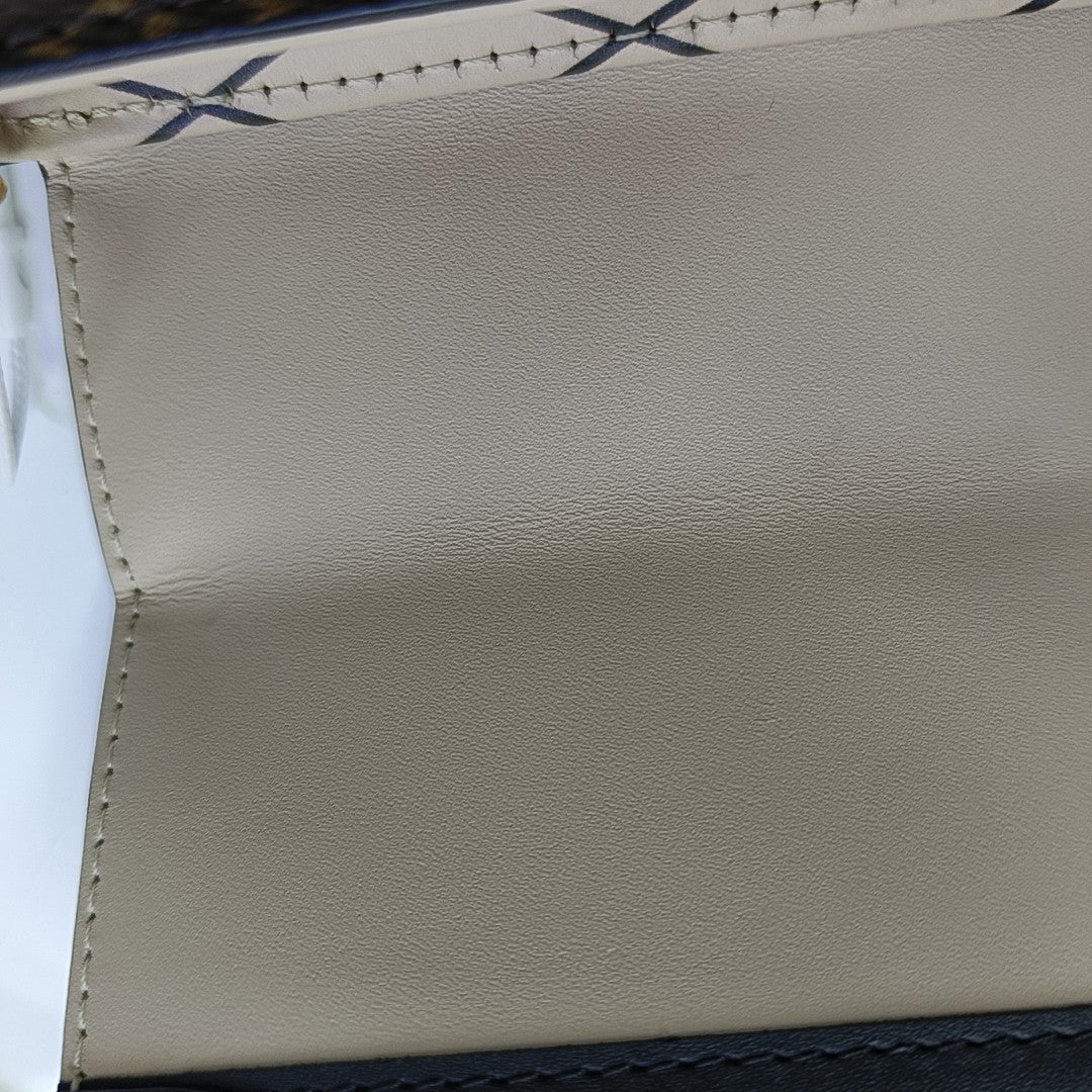 TRUNK Monogram Coated Canvas Brown