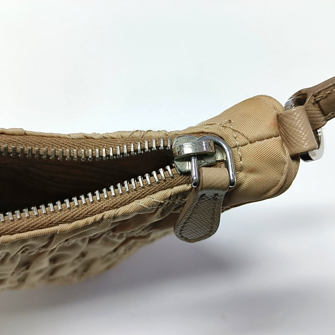 Authenticated pre-owned  Re-Edition2005 Mini Quilted Nylon Beige - Top Handle Bag at Looply