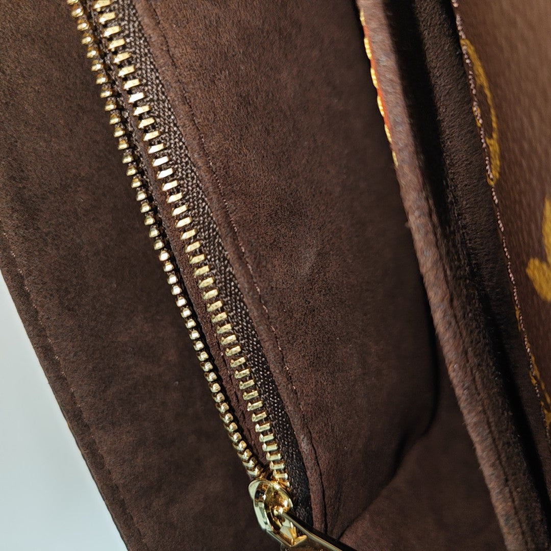 MÉTIS EAST WEST Monogram Coated Canvas Brown