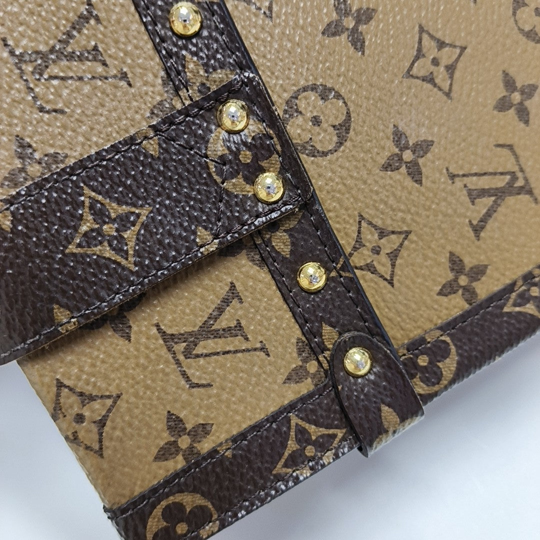 TRUNK Monogram Coated Canvas Brown
