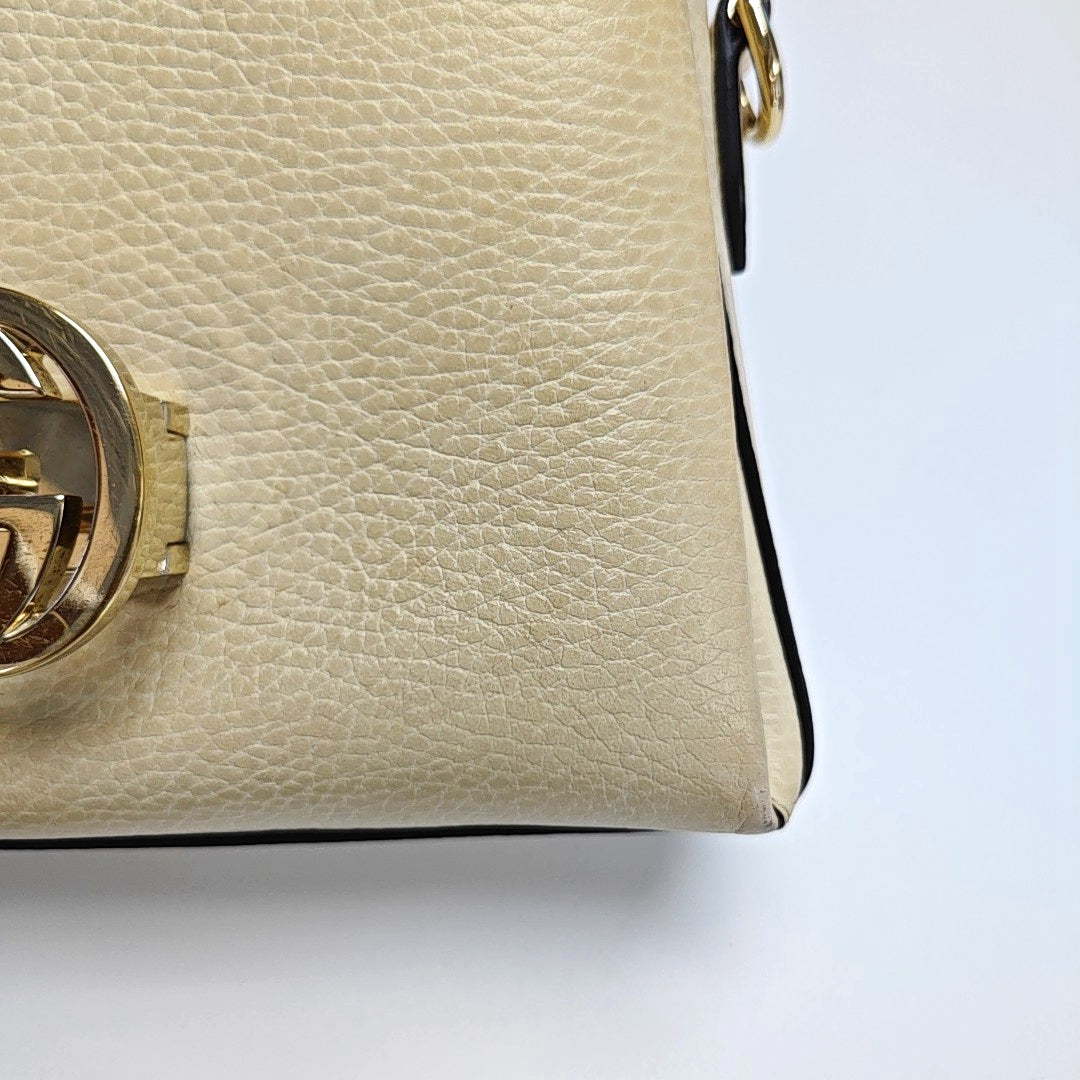 Piel de becerro mini con G entrelazada Beige