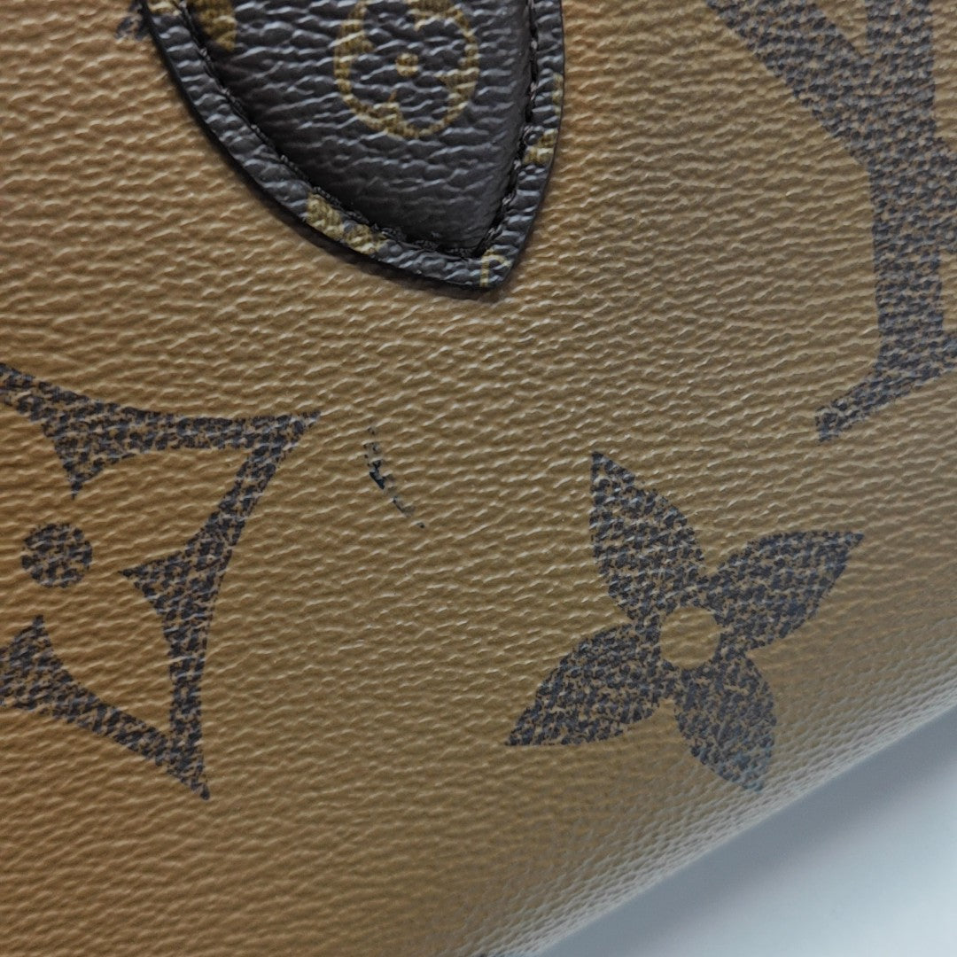 ONTHEGO EAST WEST PM Monogram Coated Canvas Brown