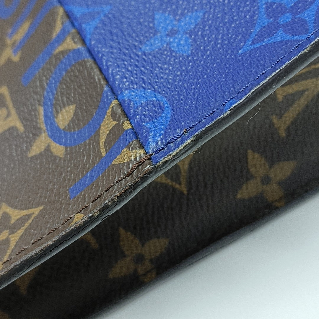 Pochette Voyag MM Monogram Coated Canvas Blue