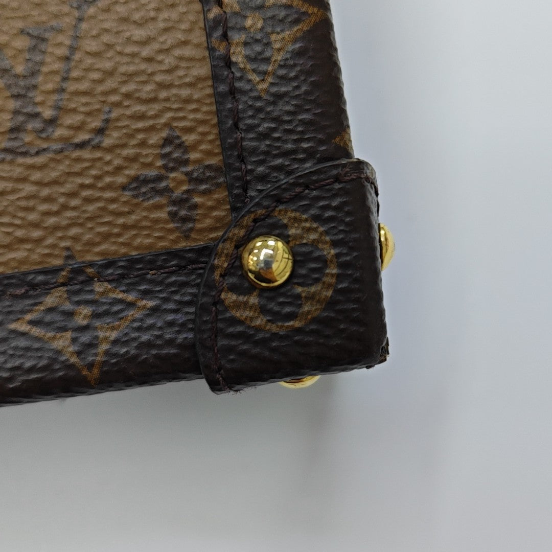 TRUNK Monogram Coated Canvas Brown