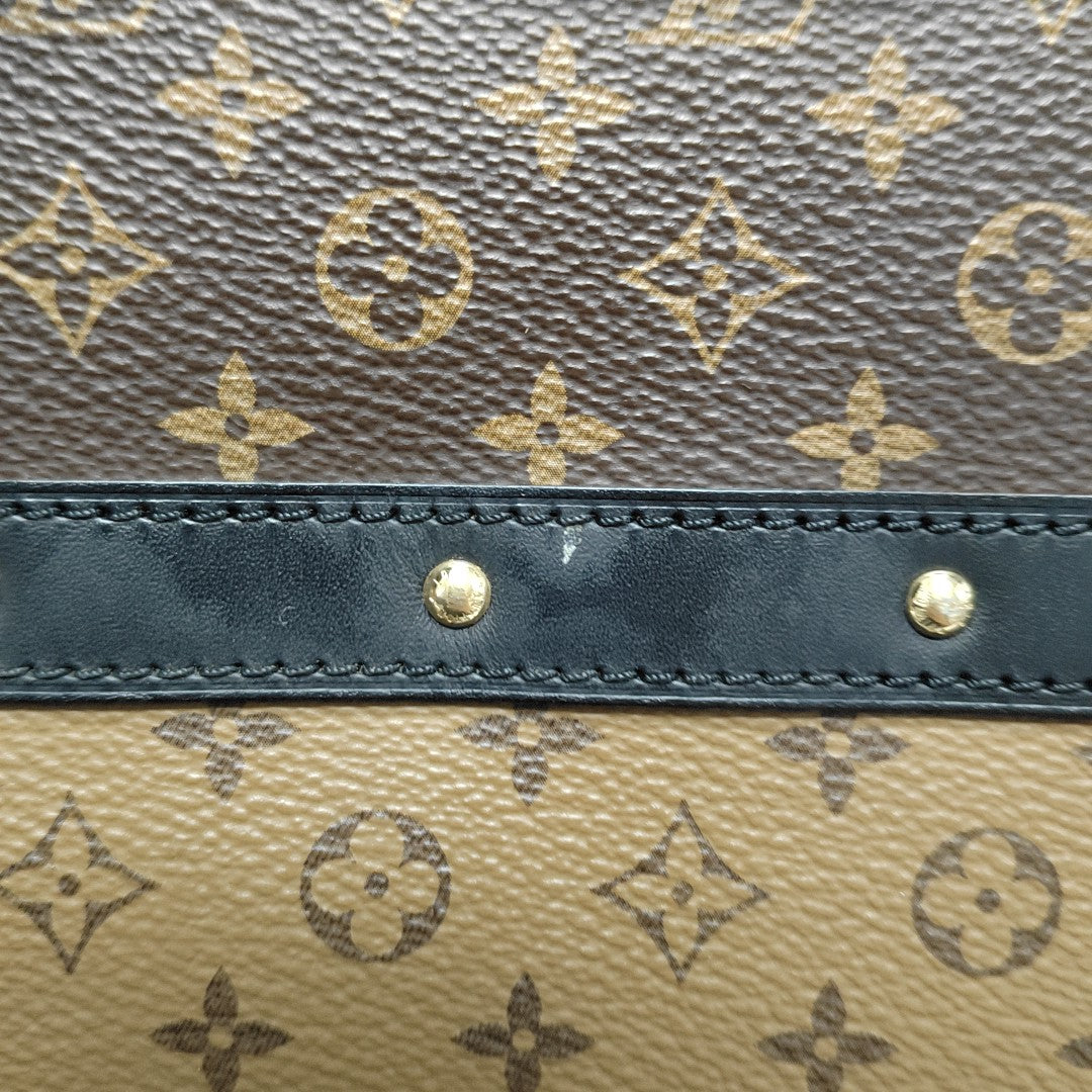 TRUNK Monogram Coated Canvas Brown