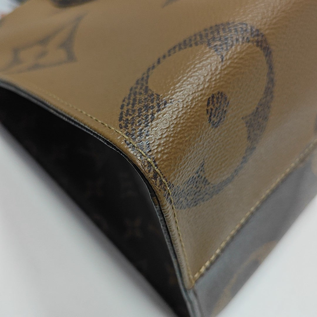 ONTHEGO MM Monogram Coated Canvas Brown