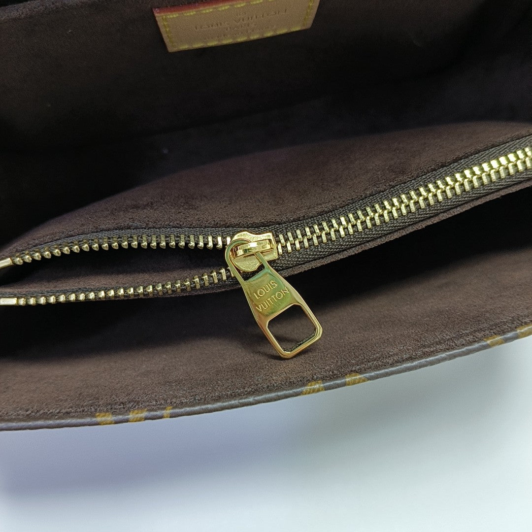 MÉTIS EAST WEST Monogram Coated Canvas Brown
