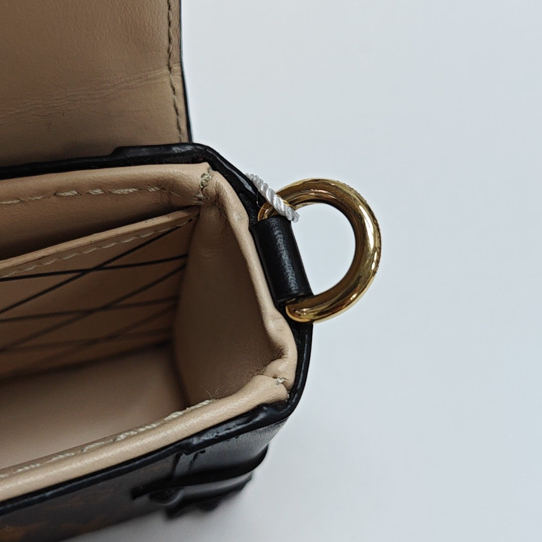TRUNK Monogram Coated Canvas Brown