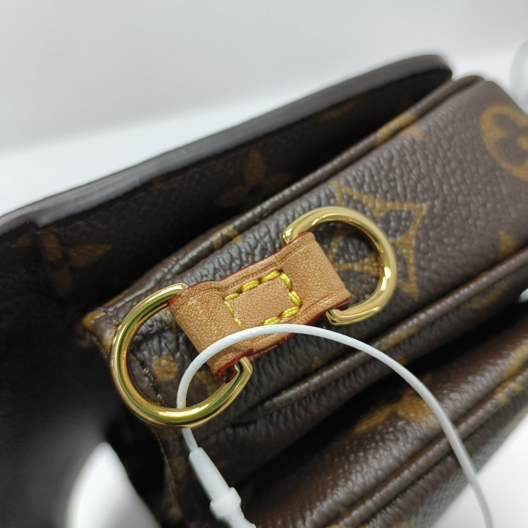 MÉTIS EAST WEST Monogram Coated Canvas Brown