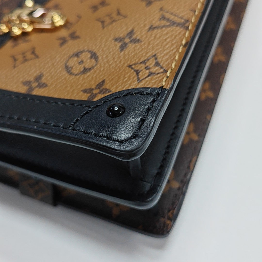 TRUNK Monogram Coated Canvas Brown