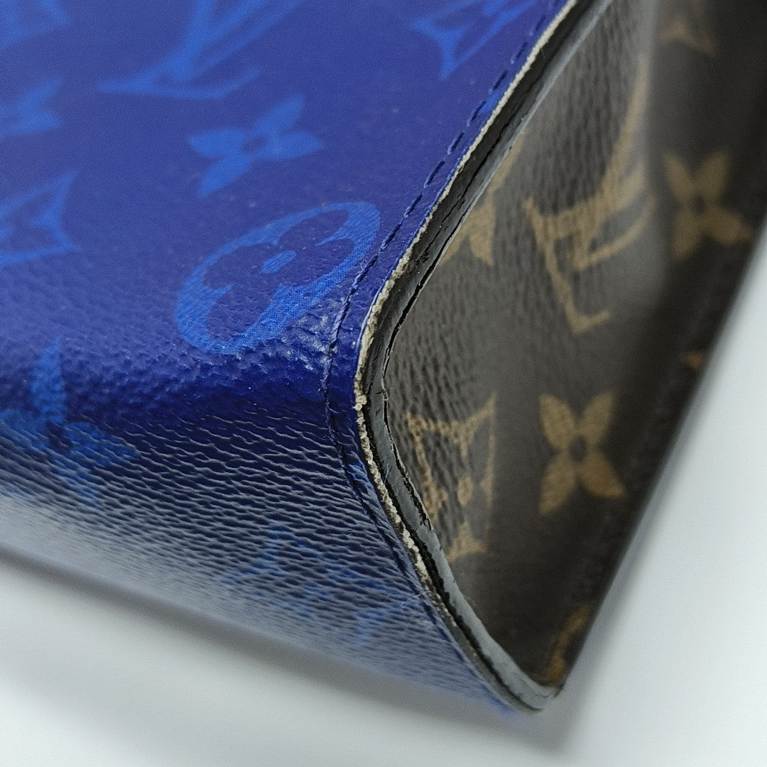Pochette Voyag MM Monogram Coated Canvas Blue