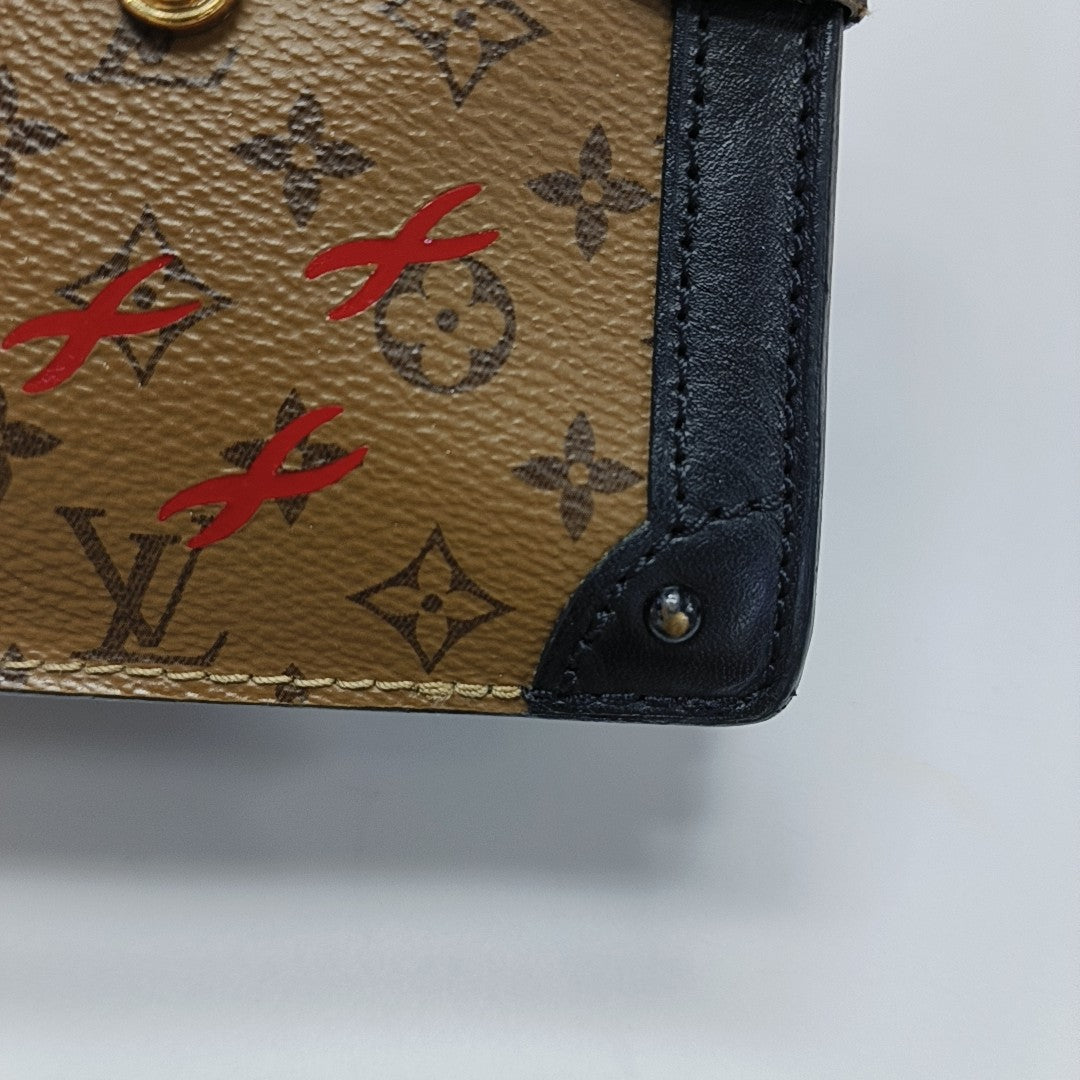 TRUNK Monogram Coated Canvas Brown