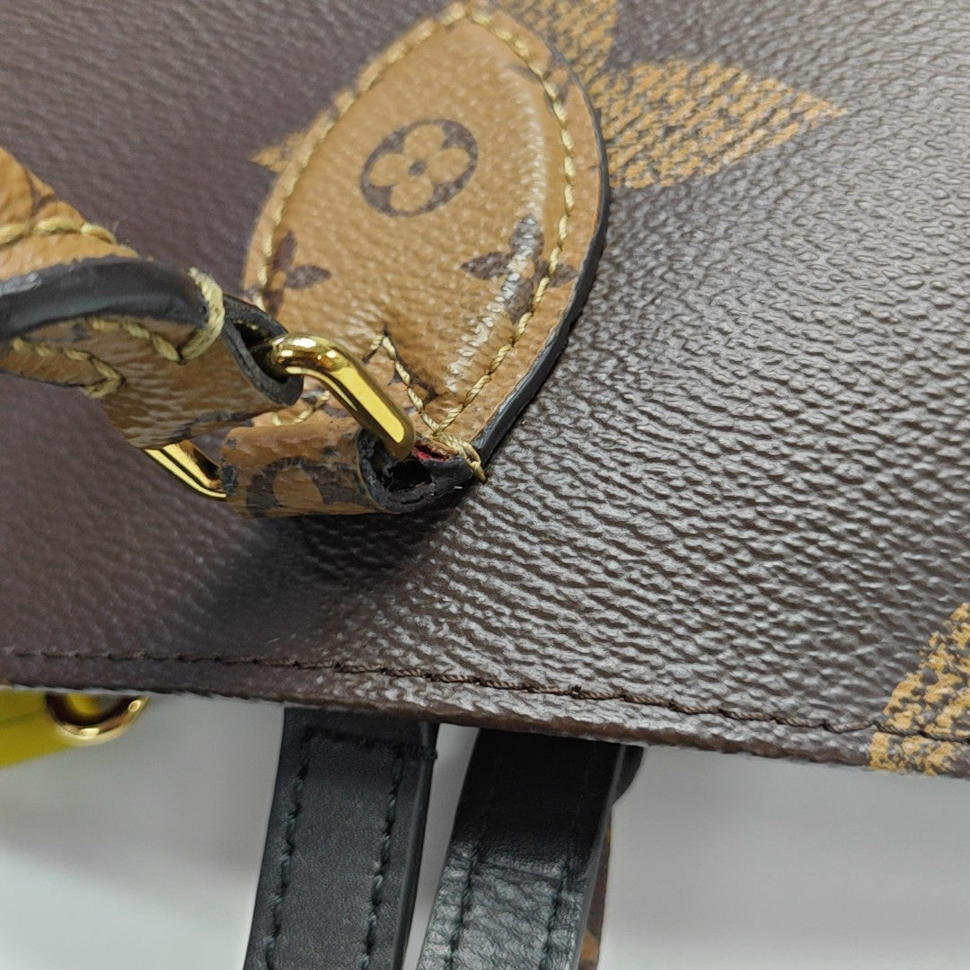 ONTHEGO MM Monogram Coated Canvas Brown