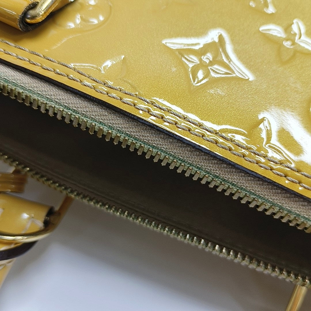 Authenticated pre-owned  Alma PM Monogram Patent Leather Yellow - Top Handle Bag at Looply