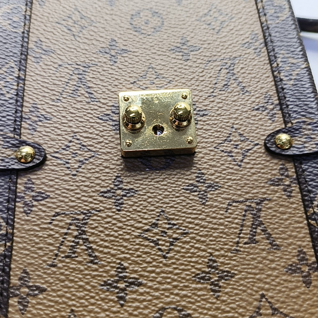 TRUNK Monogram Coated Canvas Brown