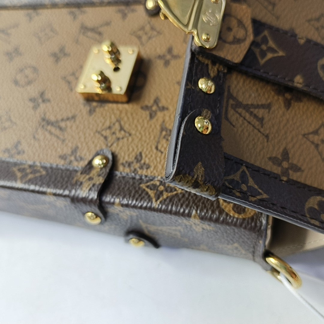 TRUNK Monogram Coated Canvas Brown