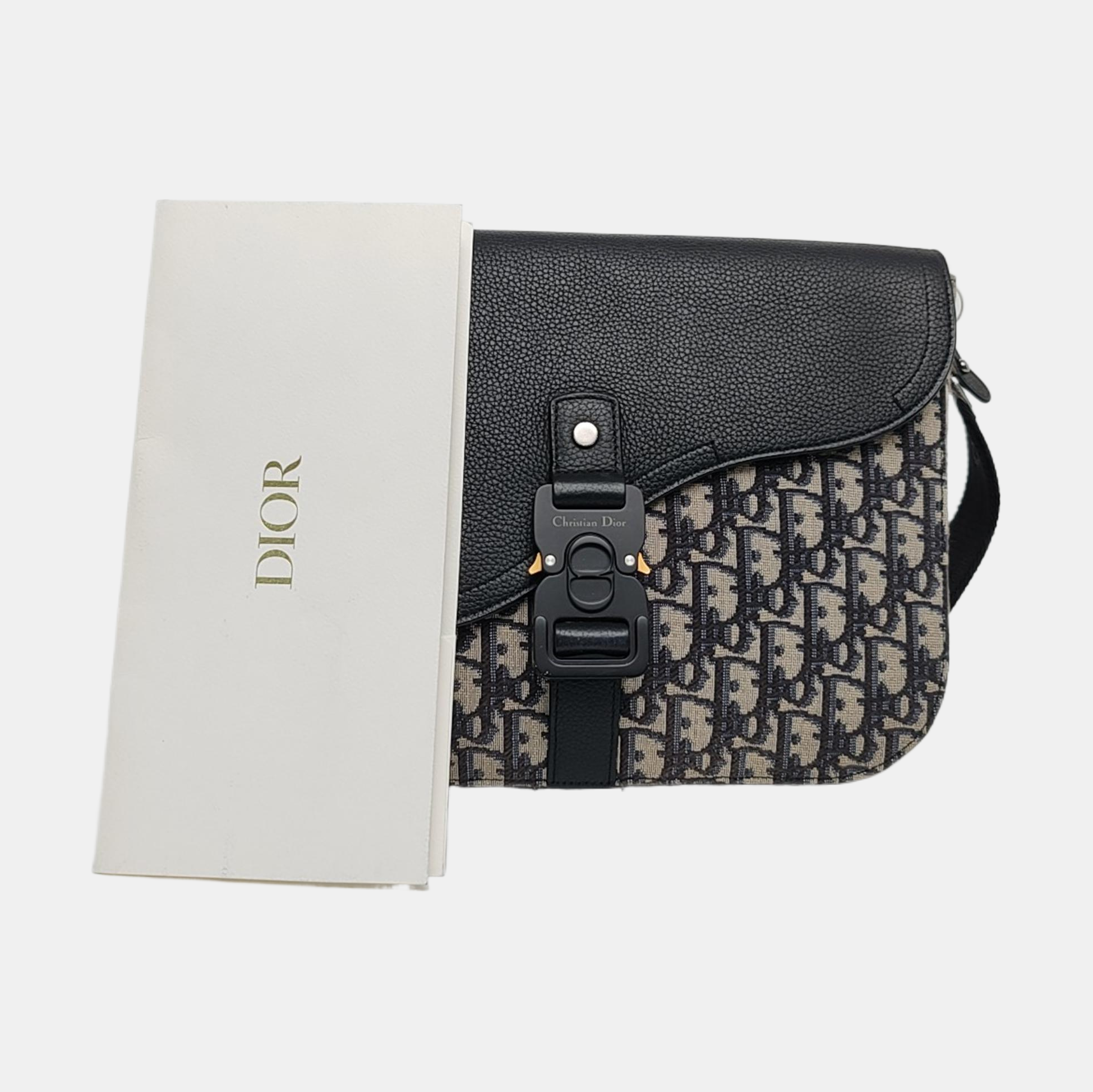 Authenticated pre-owned  Saddle Oblique Canvas Beige - Clutch at Looply
